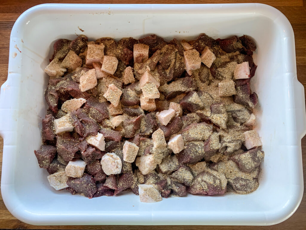 Cubed venison, pork fat, and spices